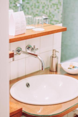 a white sink in a bathroom with a counter at Hotel Zum Ochsen in Oberstenfeld