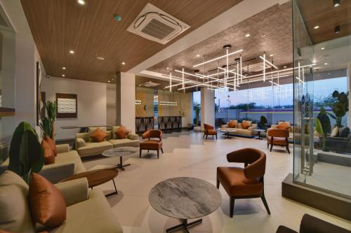 a lobby of a hospital with couches and tables at Click Hotel Pithampur in Mhow