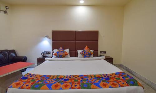 a bedroom with a large bed in a room at FabHotel RR Suites Guwahati in Guwahati