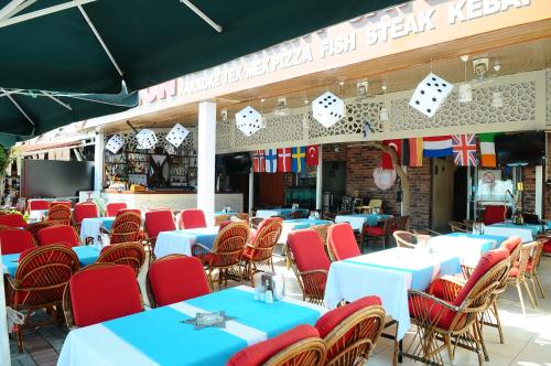 a row of tables and chairs in a restaurant at Kleopatra Beach Yildiz Hotel in Alanya