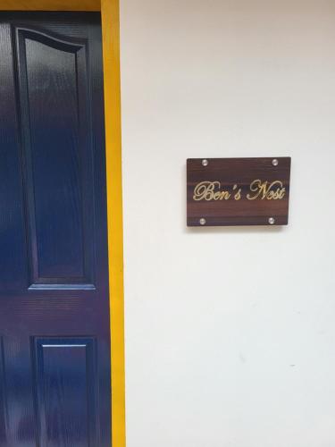 a sign on a wall next to a door at Ben's Villa Kannur ! in Kannur