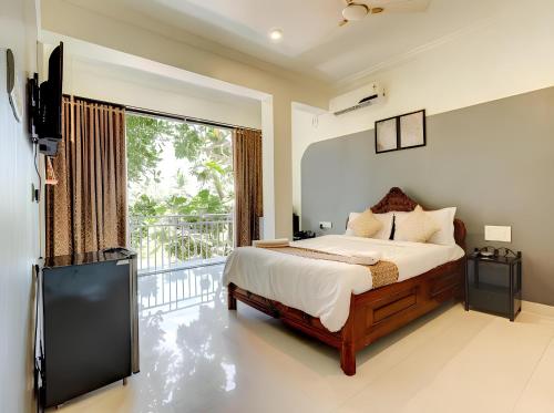 Un pat sau paturi într-o cameră la Hotel 7 Seas Vagator