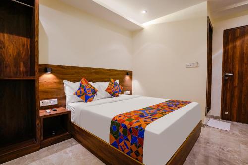 a bedroom with a large white bed in a room at FabExpress Antlers - Nr Boriwali in Mumbai