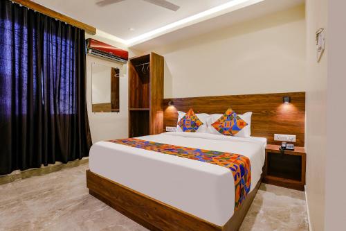 a bedroom with a large bed and a window at FabExpress Antlers - Nr Boriwali in Mumbai