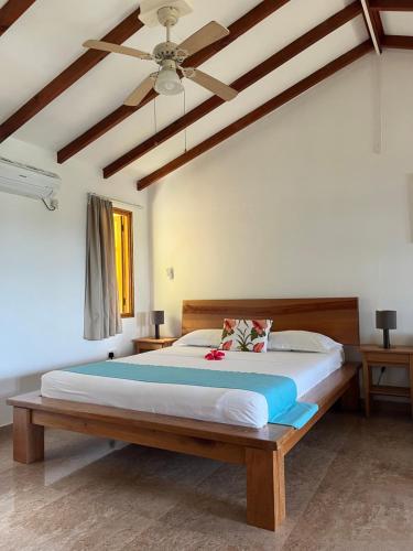 a bedroom with a large bed in a room at Maison Marikel in Mahe