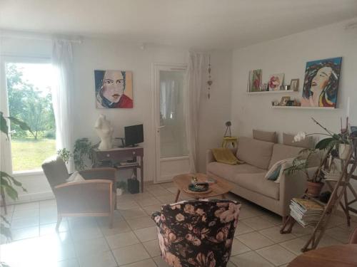 a living room with a couch and a table at Maison à la campagne idéalement située dans le 63 in Beauregard-lʼÉvêque