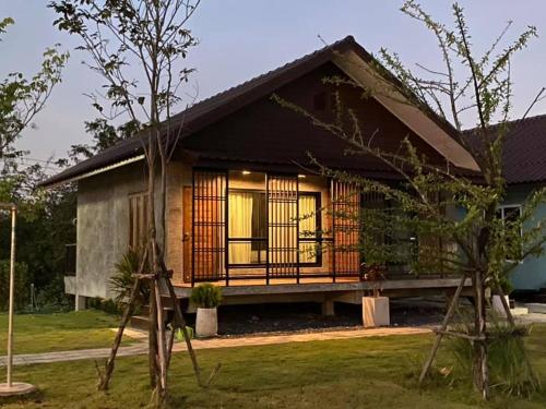 a small house with a large front porch at P Villa Homestay in Ban Bang Krasan