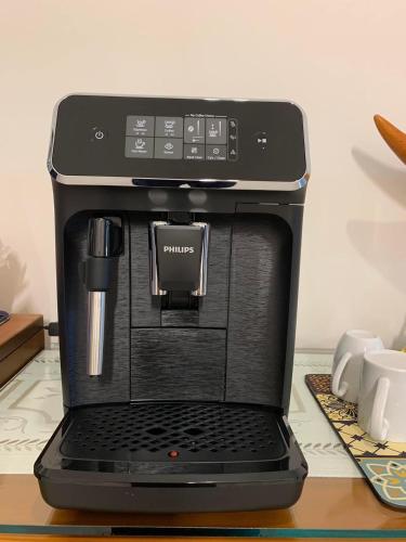 a black coffee maker with a laptop on a table at 芯之所嚮 in Hualien City