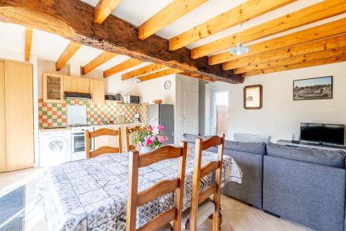 a kitchen and living room with a table and a couch at Maison de vacances 4 pers in Saint-Just