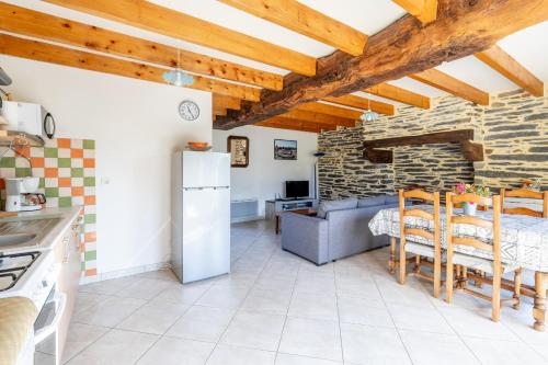 a kitchen with a table and a refrigerator in a room at Maison de vacances 4 pers in Saint-Just