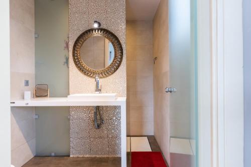a bathroom with a sink and a mirror at Blue Horizon Villa in Malia