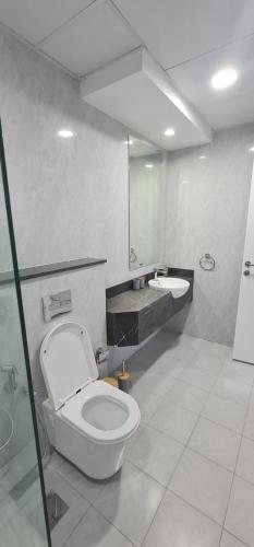 a bathroom with a toilet and a sink at Dar Alsalam - Spacious and Bright 1BR Apartment in Majan in Dubai