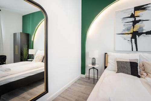 a bedroom with a large mirror and a bed at R6 - Boutique Apartments, Best Location By BQA in Budapest