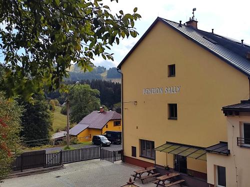 un edificio con un cartello che legge lo studio di vacanza di Penzion Sally a Albrechtice v Jizerských horách