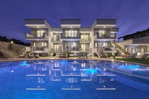 a large swimming pool in front of a building at New Crete apartment in Stavromenos Coast w/pool in Stavromenos
