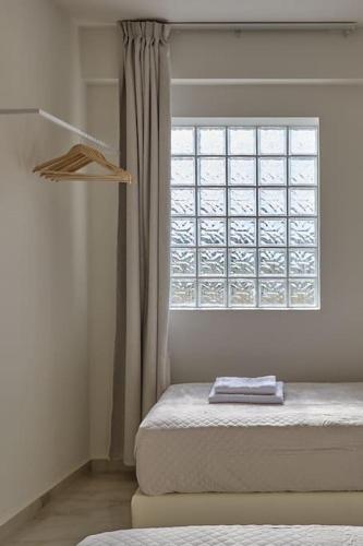 a bedroom with a window with a book on the bed at New Crete apartment in Stavromenos Coast w/pool in Stavromenos