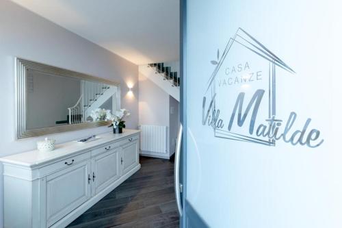 a bathroom with a sink and a mirror at Villa Matilde in Sanremo