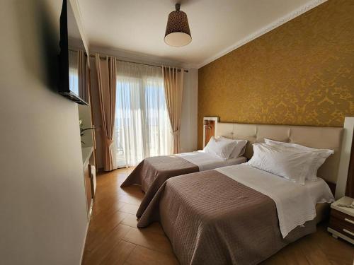 Ένα ή περισσότερα κρεβάτια σε δωμάτιο στο Hotel Gold