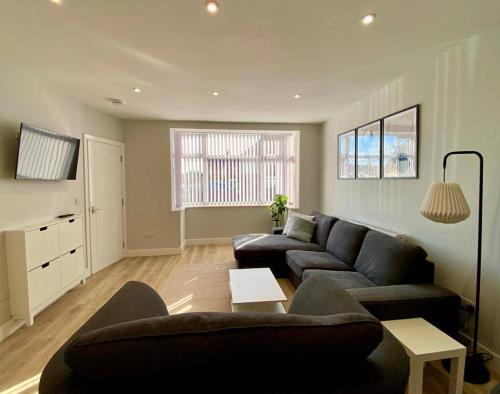 a living room with a couch and a table at Gable House in Crewe