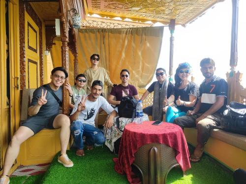 a group of people posing for a picture on a train at Houseboat in Ameerpet