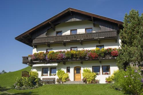 a house with flowers on the side of it at Schwendter-Hof in Westendorf