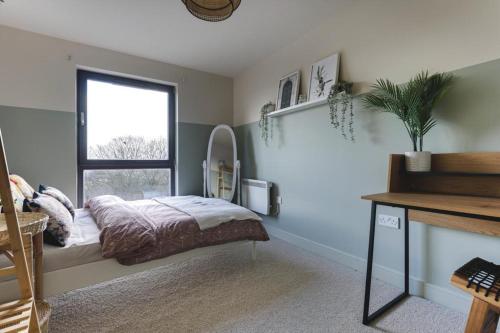 a bedroom with a bed and a window at Large river view room in London