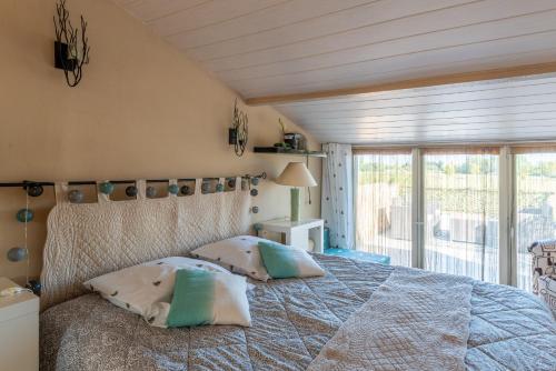 a bedroom with a bed with two pillows on it at Aux portes de la Camargue in Manduel
