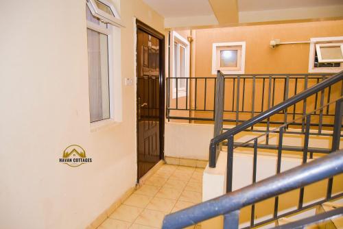 a staircase leading up to a door in a building at Havan Furnished Apartment-Milimani N9 in Nakuru