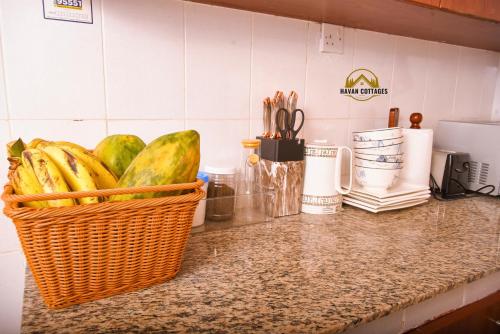 a basket of bananas on a counter in a kitchen at Havan Furnished Apartment-Milimani N9 in Nakuru