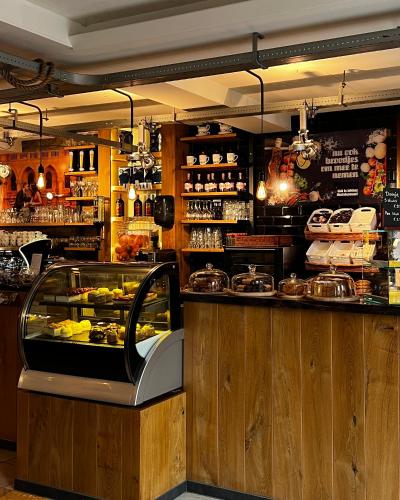 a restaurant with a counter with food on display at Bed en Baguette in Burgh Haamstede