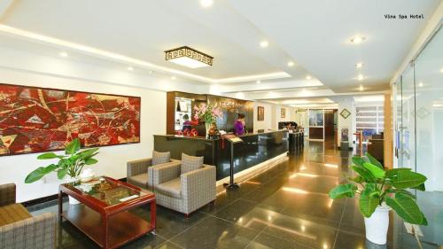 a lobby of a hotel with a table and chairs at Vina Spa Hotel in Hue