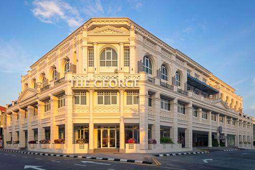 a large yellow building on the corner of a street at The George Penang by The Crest Collection in George Town