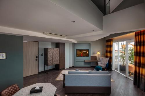 a living room with a couch and a table at The George Penang by The Crest Collection in George Town