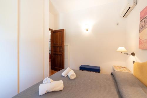 a bedroom with a bed with towels on it at Amazing sunset with swimming pool in Custonaci