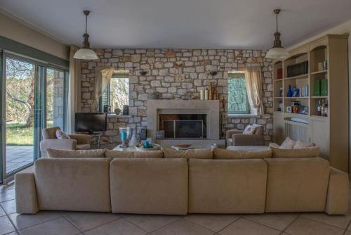 a living room with a couch and a fireplace at Villa Leon in Chalkida