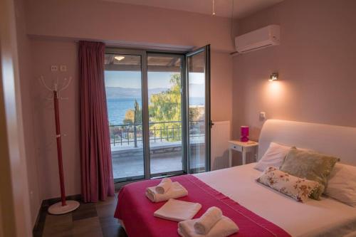 a bedroom with a bed with a view of the ocean at Villa Leon in Chalkida