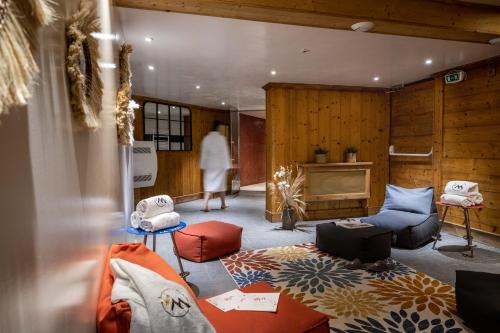 a living room with a couch and chairs and a fireplace at Hôtel Ski Lodge - Chambres & Appartements - Village Montana in Val dʼIsère