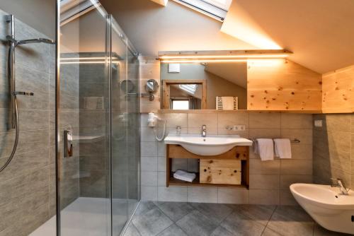 a bathroom with a sink and a shower at Widmannhof - Urlaub auf dem Biobauernhof in Bressanone