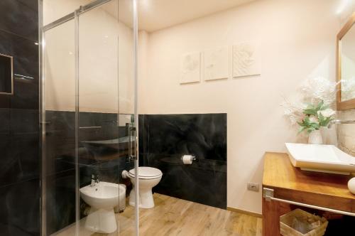 a bathroom with a shower and a toilet and a sink at Il Piccolo Borgo for 7 guests in Certaldo