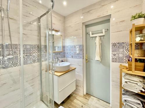 a bathroom with a glass shower and a sink at Family-Friendly Home in Bratislava in Bratislava