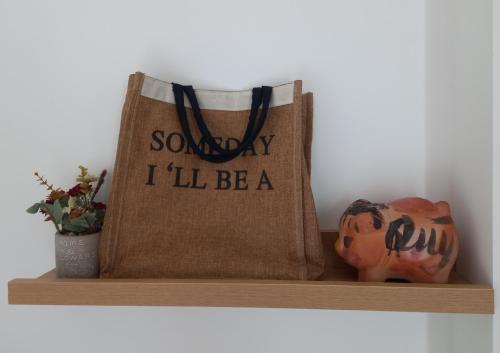 a tote bag sitting on a shelf with a pumpkin at Chang Homestay in Quy Nhon