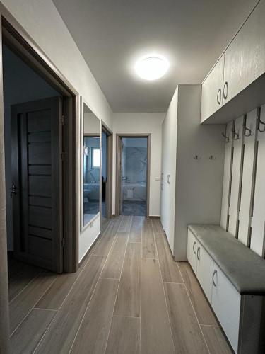 a room with a hallway with a bench and a door at Cozy Studios in Suceava in Suceava