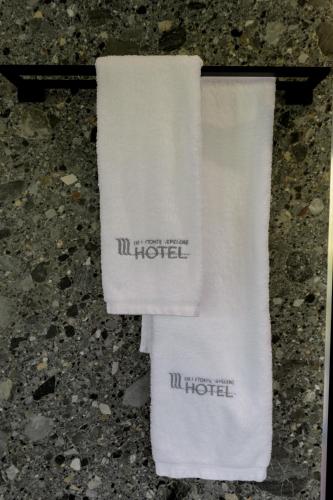 a white towel with the hotel written on it at Hotel Uji Ftohte Tepelene in Tepelenë