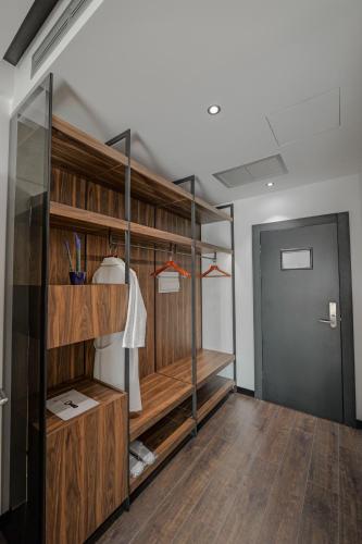a room with wooden shelves and a door at Hotel Uji Ftohte Tepelene in Tepelenë