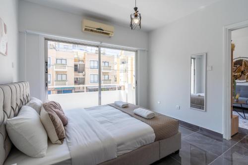 una camera con un letto e una grande finestra di Powder’s 1-Bedroom Retreat in Mackenzy, Larnaca a Larnaka