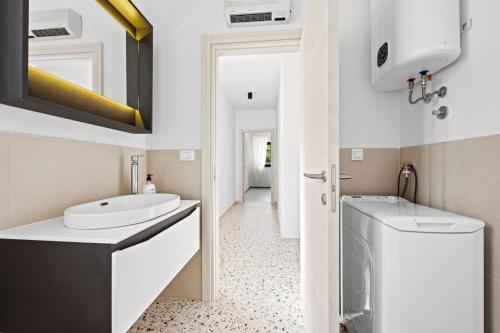 a bathroom with a sink and a washing machine at Charming apartment Emilija in Pula