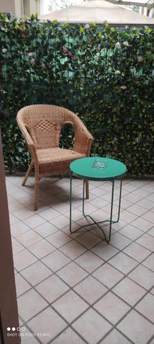 a wicker chair and a table on a patio at A casa di Rosy in Casalecchio di Reno