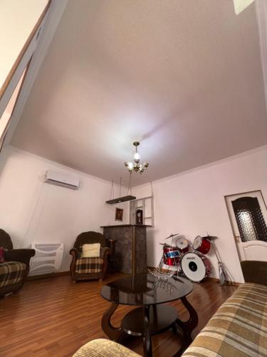 a living room with a couch and a table at House - Kutaisi International Airport 15 Minutes, Samtredia Kulashi 15Tamar Mepe Street in Samtredia