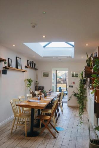 a dining room with a long table and chairs at Upstairs at 33 - Self check in boutique accommodation in Worcester Centre in Worcester