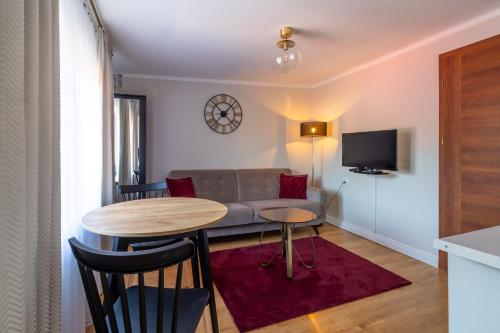 a living room with a couch and a table at Apartamenty „Nad Popradem” in Rytro